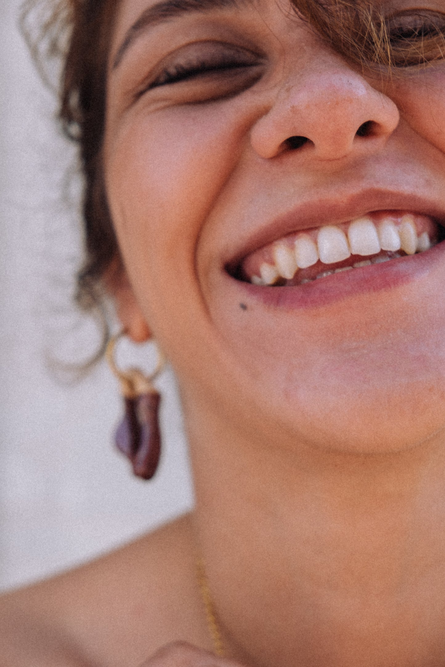 Burgundy ceramic earrings in motion — lightweight handmade Mosca design with glossy finish, made in Lisbon