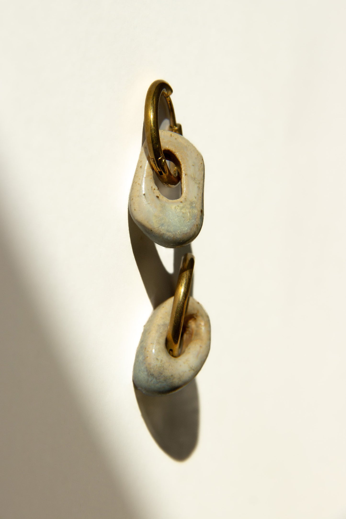Azoia handmade ceramic earrings in Sparkling White — subtle small hoop, everyday elegance, made in Lisbon Portugal by Jadeo Studio, silver and gold hoop