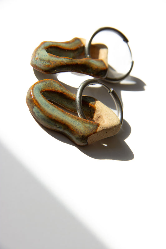 Mosca handmade ceramic earrings in Grey Green — organic sculpted clay with glossy glaze, statement jewelry made in Lisbon Portugal by Jadeo Studio