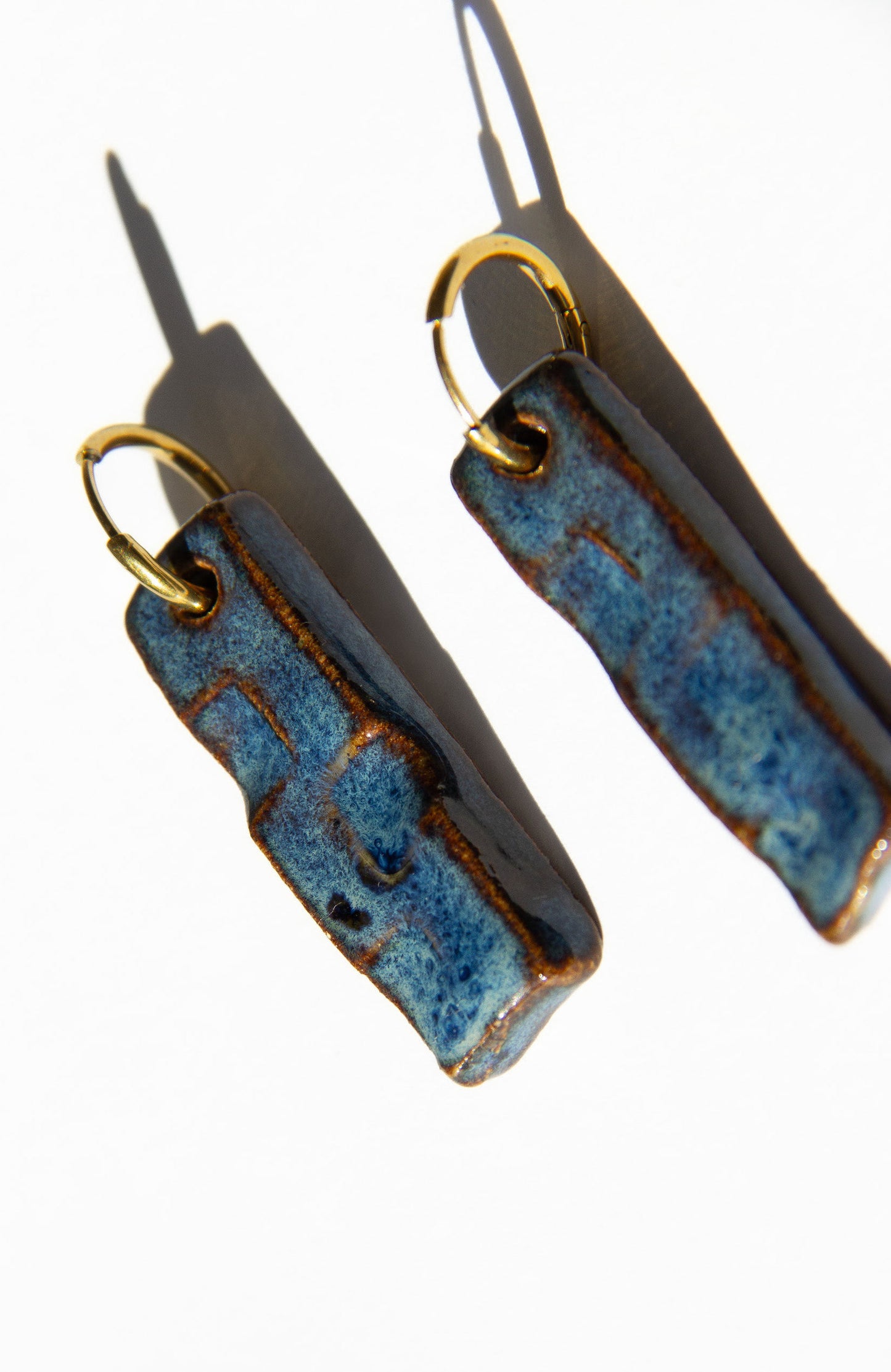 Penha handmade ceramic earrings in Blue Jeans — minimalist rectangular drop, sculpted clay, made in Lisbon Portugal by Jadeo Studio, silver and gold hoop