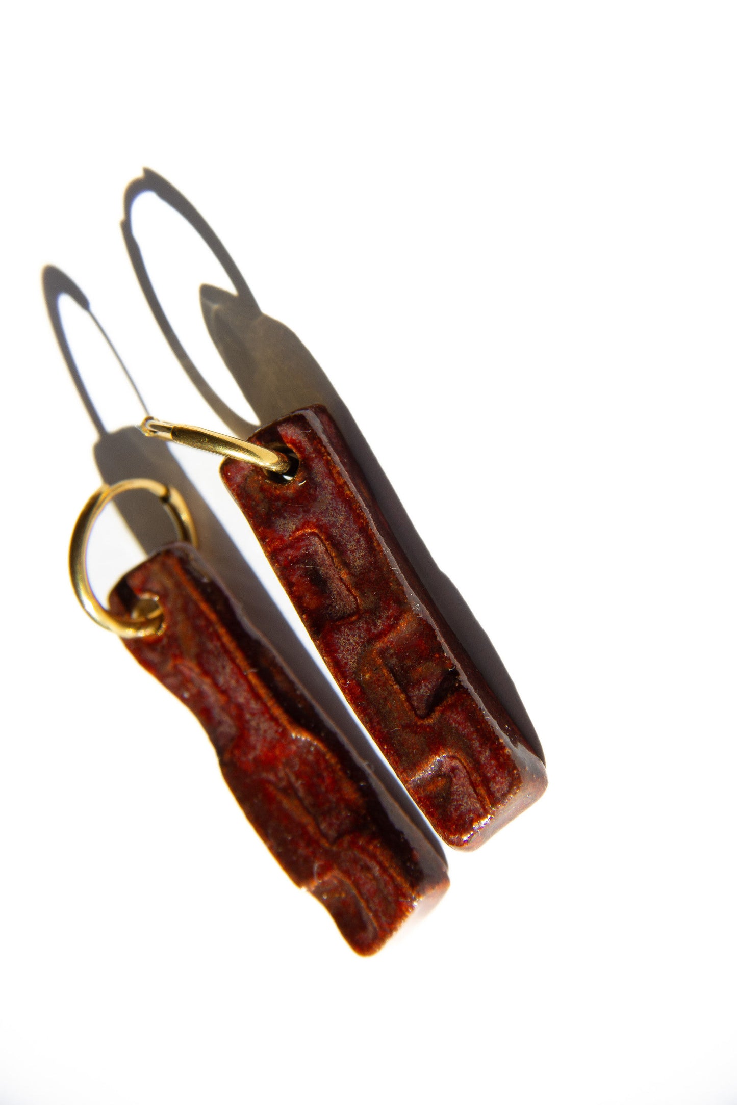 Penha handmade ceramic earrings in Burgundy — minimalist rectangular drop, sculpted clay, statement jewelry made in Lisbon Portugal by Jadeo Studio