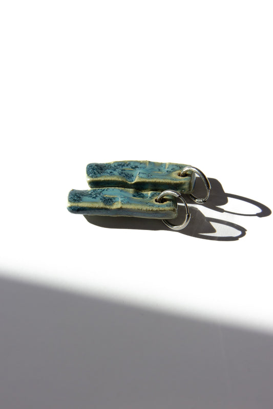 Penha handmade ceramic earrings in Sparkling Blue, glossy glaze — minimalist rectangular drop, sculpted clay, made in Lisbon Portugal by Jadeo Studio