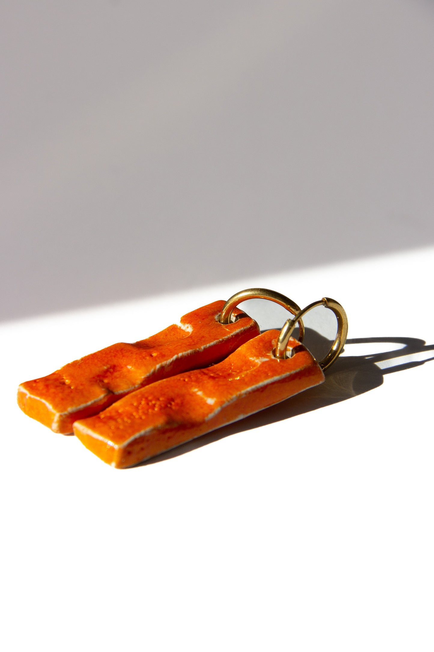 Penha handmade ceramic earrings in Volcano — minimalist rectangular drop, sculpted clay, statement jewlery, made in Lisbon Portugal by Jadeo Studio