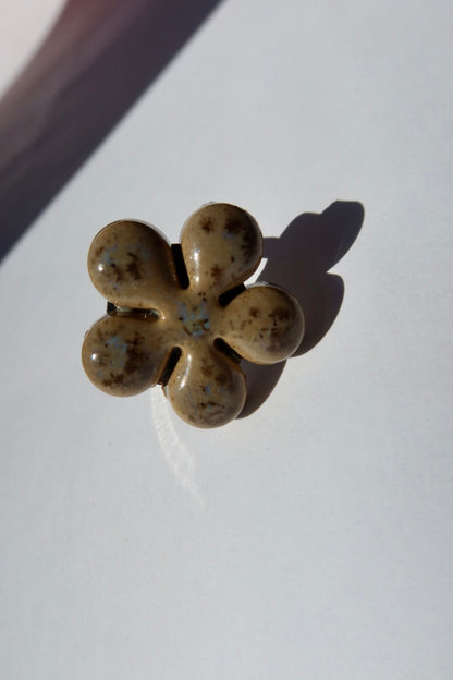 Bloom ceramic flower ring in muted beige glaze with blue speckles, handmade in Lisbon