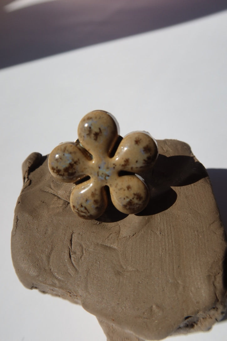 Beige ceramic flower ring with blue speckle glaze on raw clay, made in Portugal