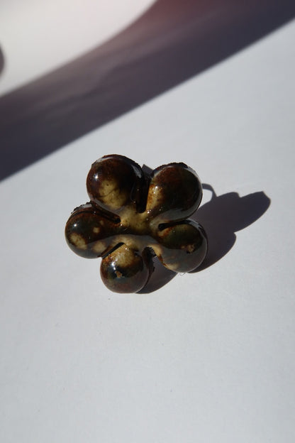 Bloom ceramic flower ring in dark green and amber glaze, handmade in Lisbon