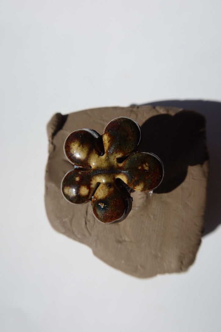 Dark green ceramic flower ring with amber glaze on raw clay, made in Portugal