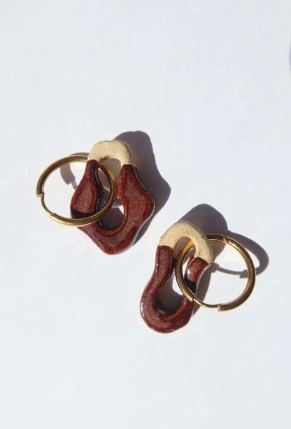 Artistic composition of Mosca burgundy earrings — colorful handmade ceramic jewelry by Jadeo Studio Lisbon