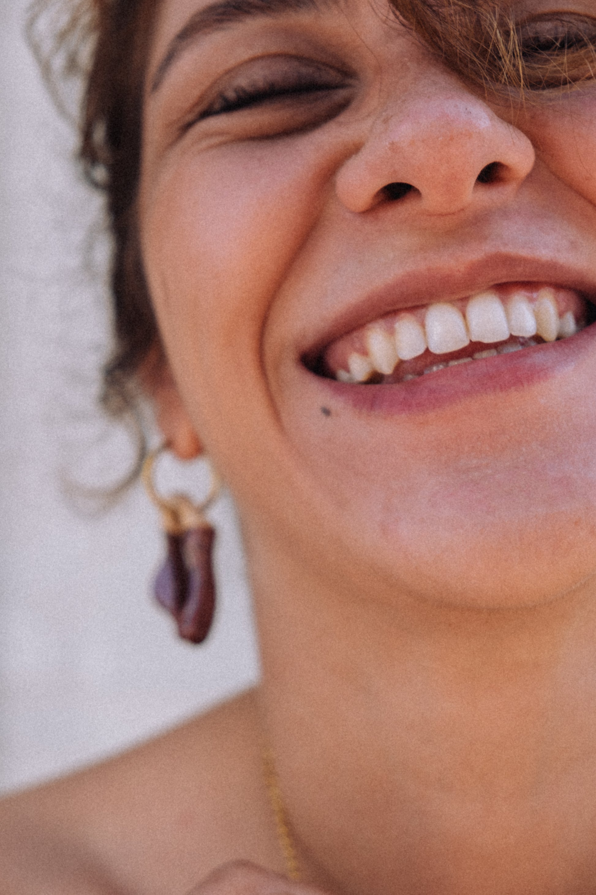 Burgundy ceramic earrings in motion — lightweight handmade Mosca design with glossy finish, made in Lisbon