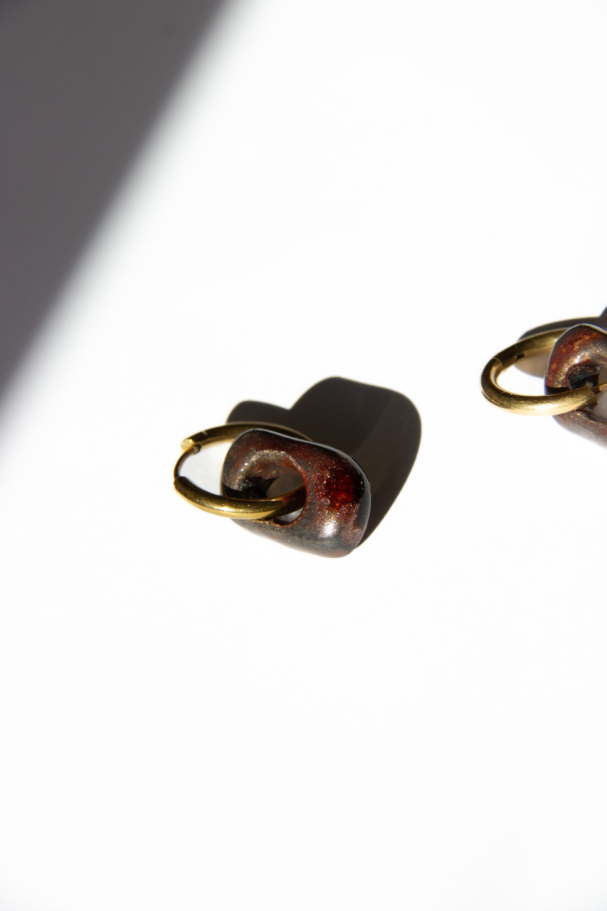 Azoia handmade ceramic earrings in Bark — subtle small hoop, everyday elegance, made in Lisbon Portugal by Jadeo Studio, silver and gold hoop