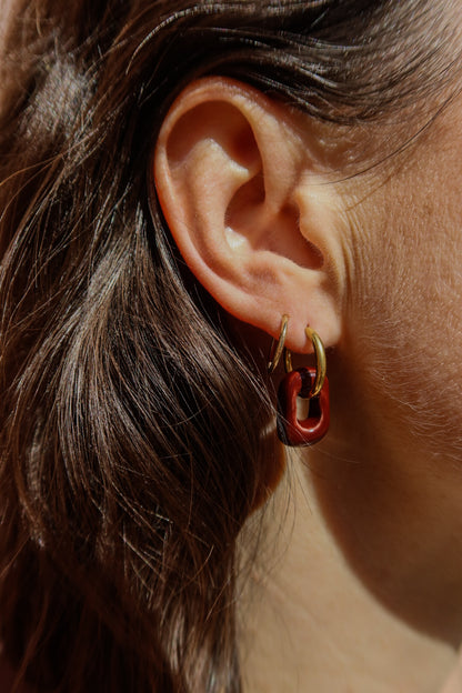 Azoia handmade ceramic earrings in Brown Red, close up on ears — subtle small hoop, everyday elegance, made in Lisbon Portugal by Jadeo Studio