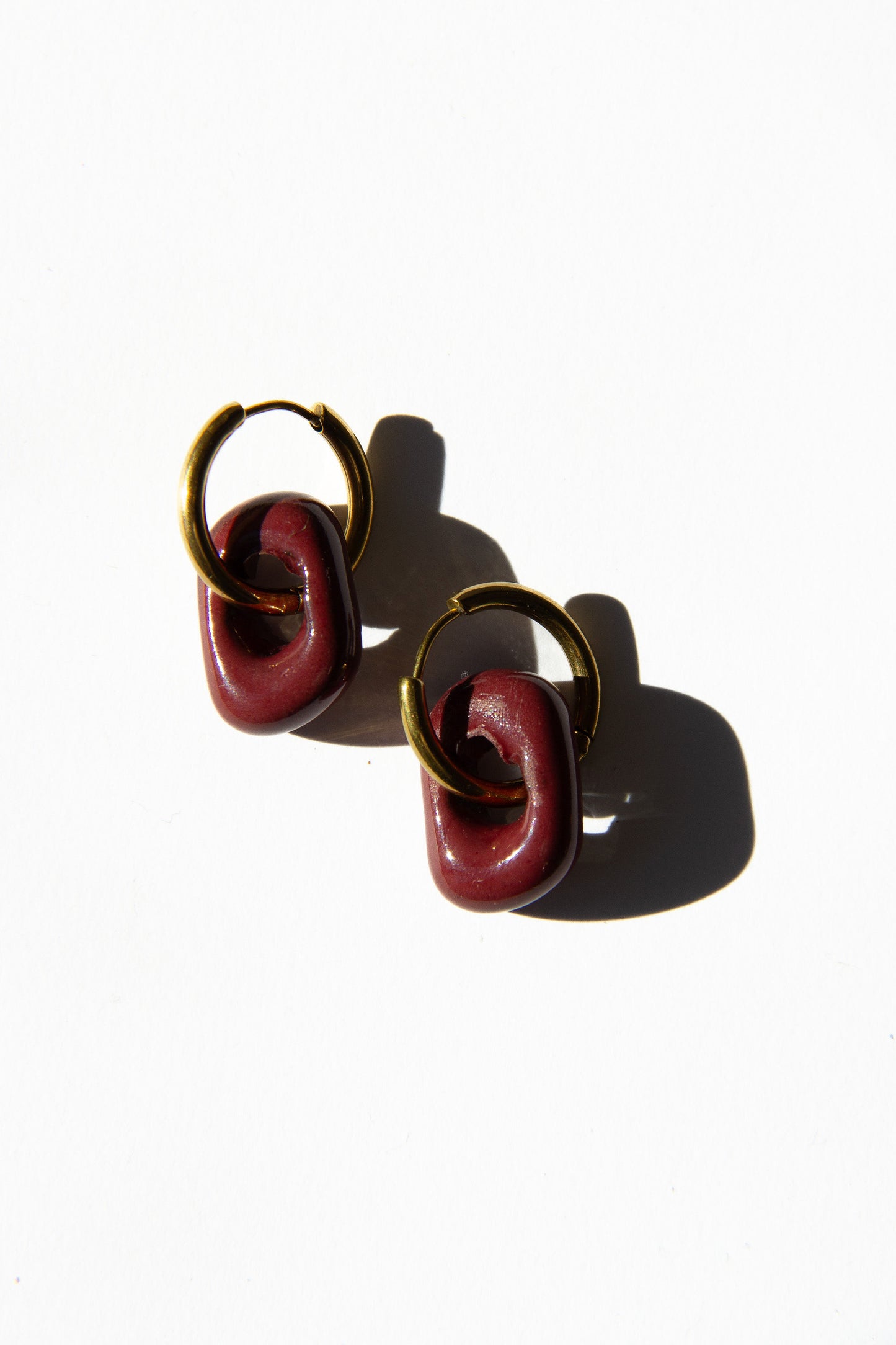 Azoia handmade ceramic earrings in Cherry — subtle small hoop, everyday elegance, made in Lisbon Portugal by Jadeo Studio