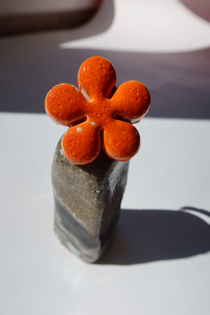 Bloom handmade ceramic flower ring in Volcano orange on ceramic holder — bold statement ring inspired by Lisbon in spring, made in Portugal by Jadeo Studio