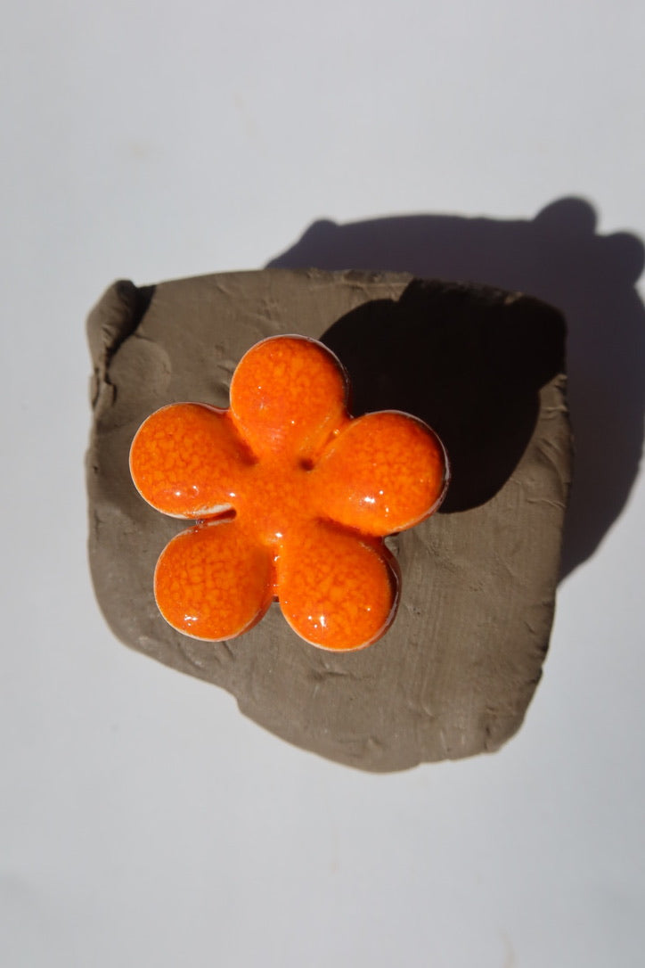 Bloom handmade ceramic flower ring in Volcano orange on raw clay — bold statement ring inspired by Lisbon in spring, made in Portugal by Jadeo Studio
