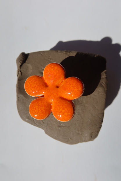 Bloom handmade ceramic flower ring in Volcano orange on raw clay — bold statement ring inspired by Lisbon in spring, made in Portugal by Jadeo Studio