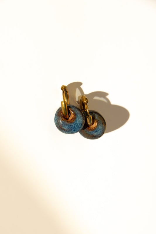 Gomes handmade ceramic earrings in Blue Jeans — rounded circular form, bold yet discreet, soft denim blue glaze, made in Lisbon Portugal by Jadeo Studio