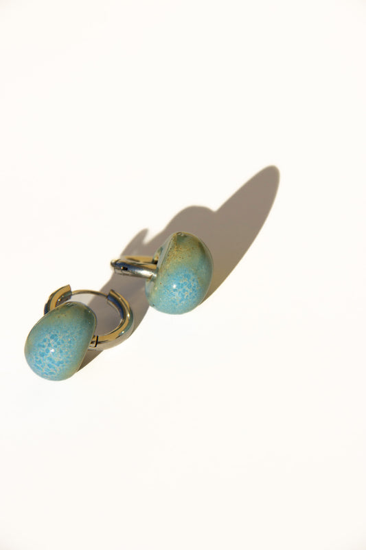 Gomes handmade ceramic earrings in Blue Sky — rounded circular form, bold yet discreet, made in Lisbon Portugal by Jadeo Studio