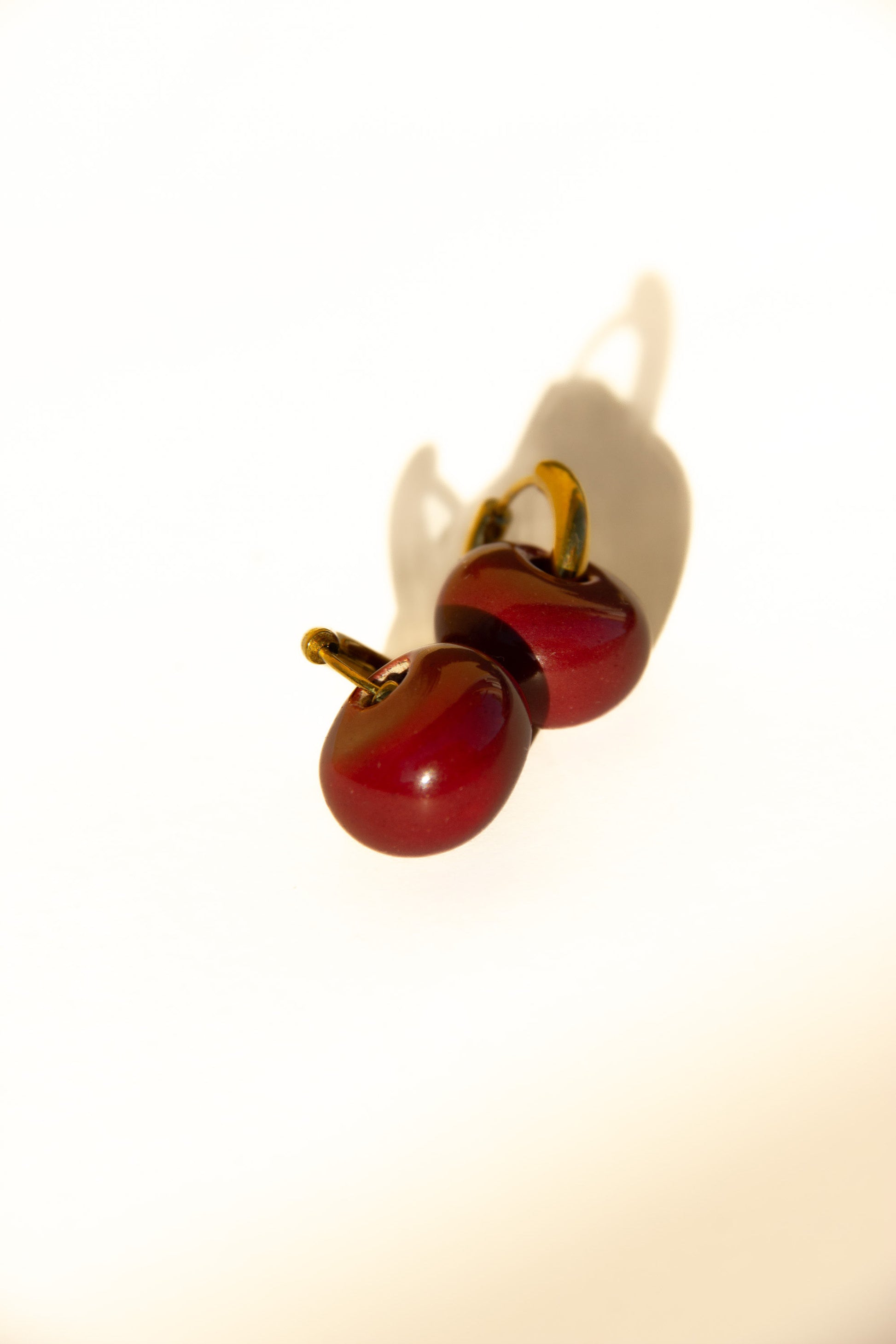 Gomes handmade ceramic earrings in Cherry — rounded circular form, bold yet discreet, made in Lisbon Portugal by Jadeo Studio, silver and gold hoop