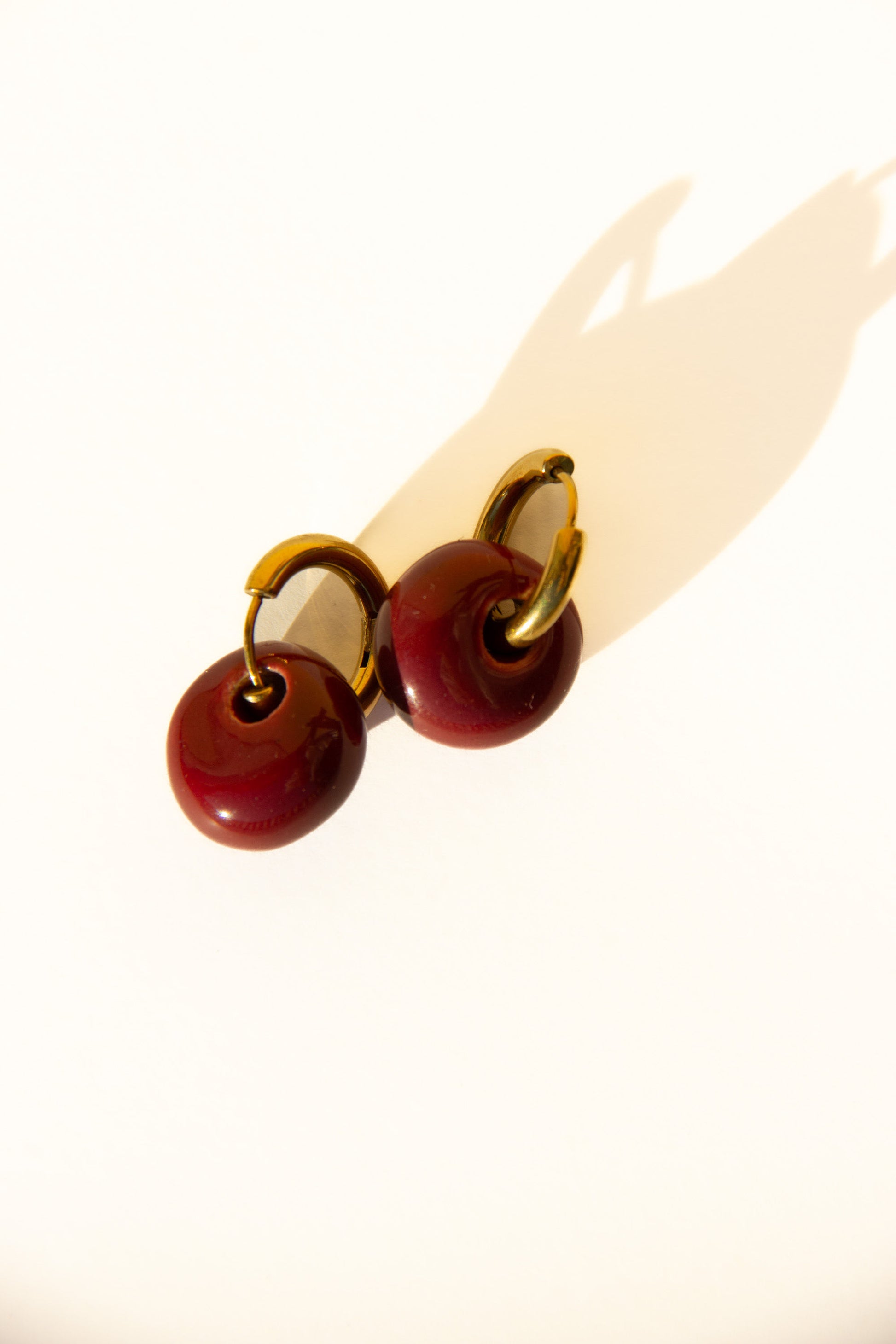 Gomes handmade ceramic earrings in Cherry — rounded circular form, bold yet discreet, made in Lisbon Portugal by Jadeo Studio