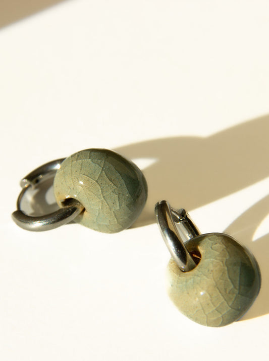 Gomes handmade ceramic earrings in Crackled Light Blue, glossy glaze — rounded circular form, bold yet discreet, made in Lisbon Portugal by Jadeo Studio