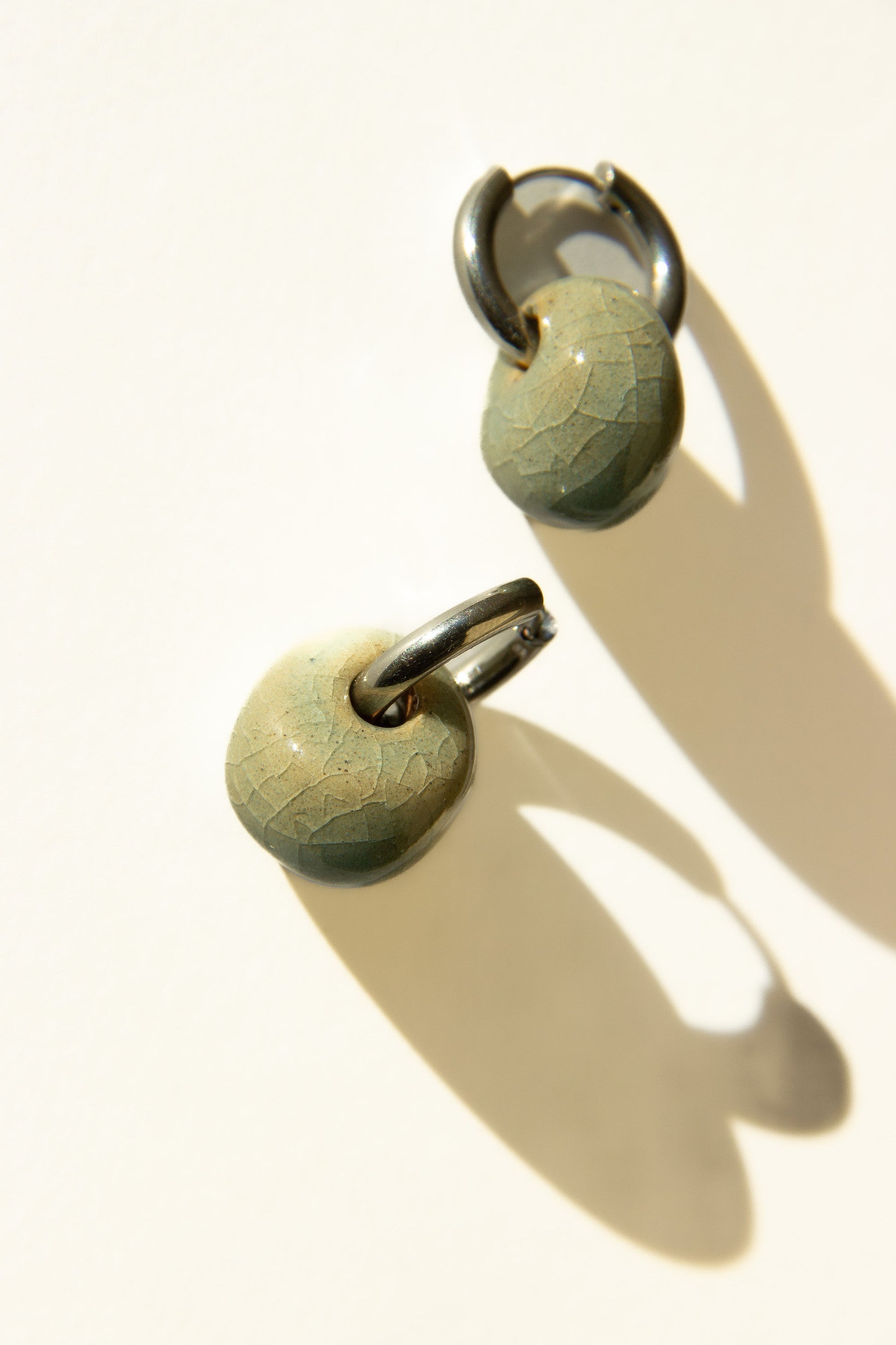 Gomes handmade ceramic earrings in Crackled Light Blue — rounded circular form, bold yet discreet, statement jewlery made in Lisbon Portugal by Jadeo Studio