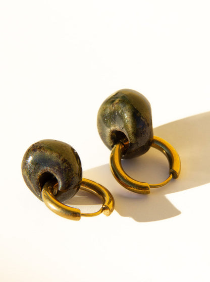 Gomes handmade ceramic earrings in Dark Green — rounded circular form, bold yet discreet, deep forest green glaze, statement jewelry made in Lisbon Portugal by Jadeo Studio