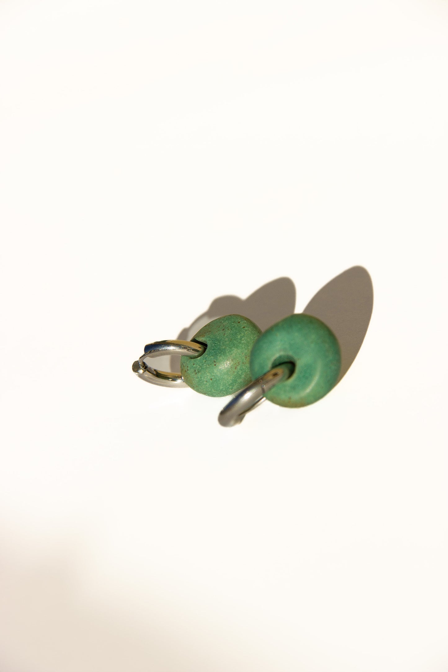 Gomes handmade ceramic earrings in Green Mat — rounded circular form, bold yet discreet, made in Lisbon Portugal by Jadeo Studio