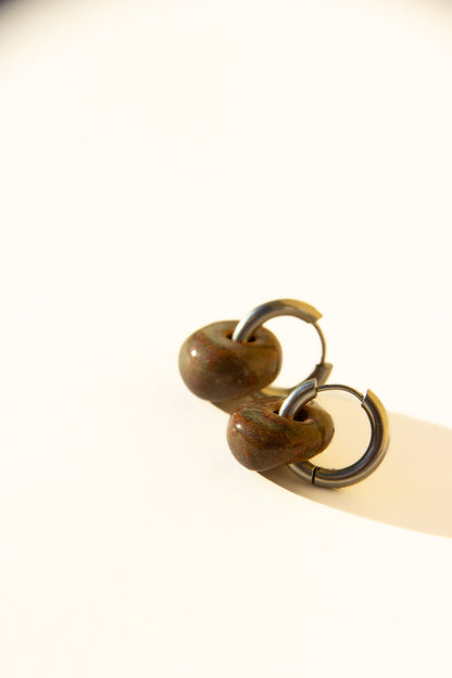 Gomes handmade ceramic earrings in Grey Green — rounded circular form, bold yet discreet, muted green-grey glaze, statement jewelry made in Lisbon Portugal by Jadeo Studio