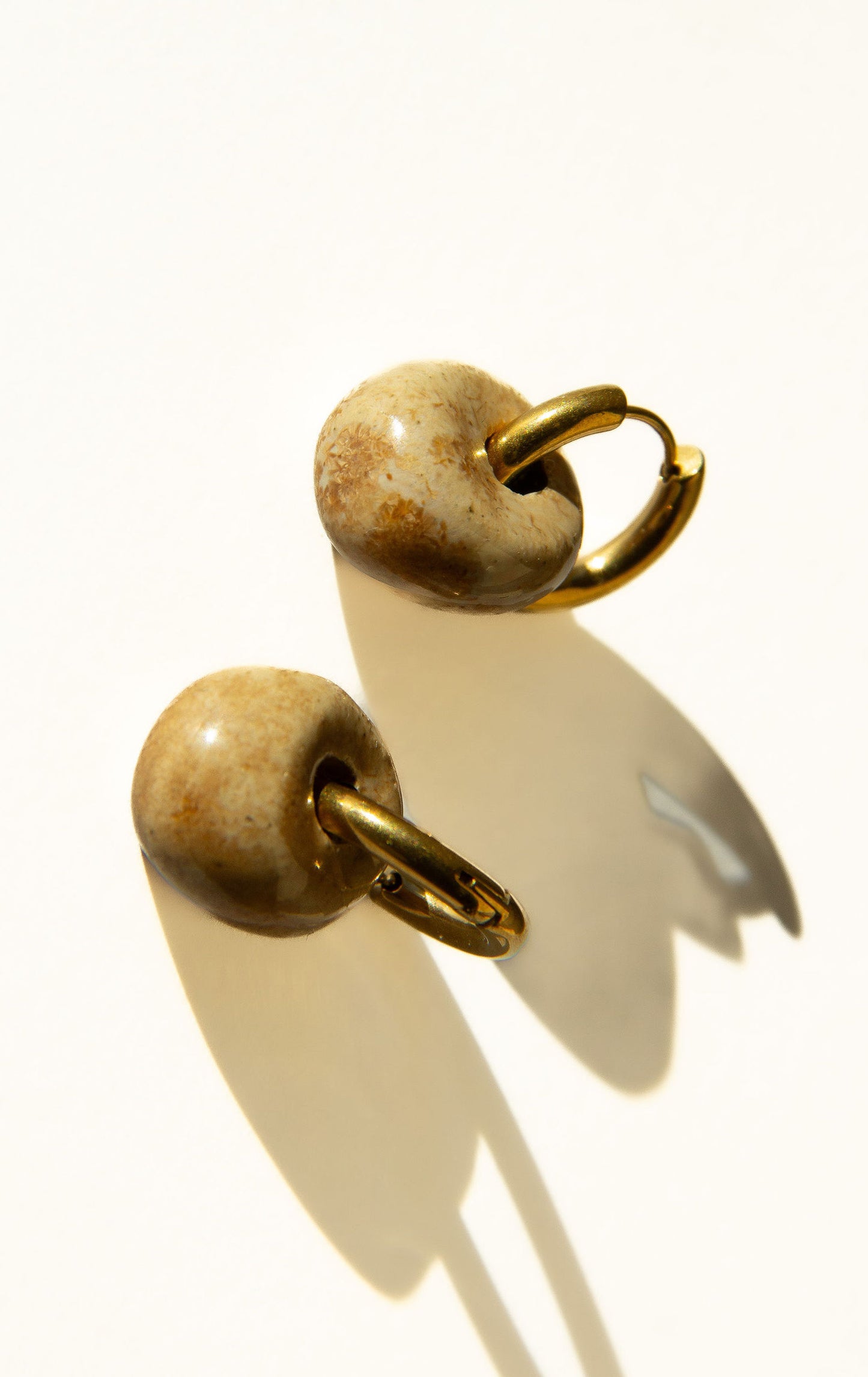 Gomes handmade ceramic earrings in Light Beige — rounded circular form, bold yet discreet, made in Lisbon Portugal by Jadeo Studio