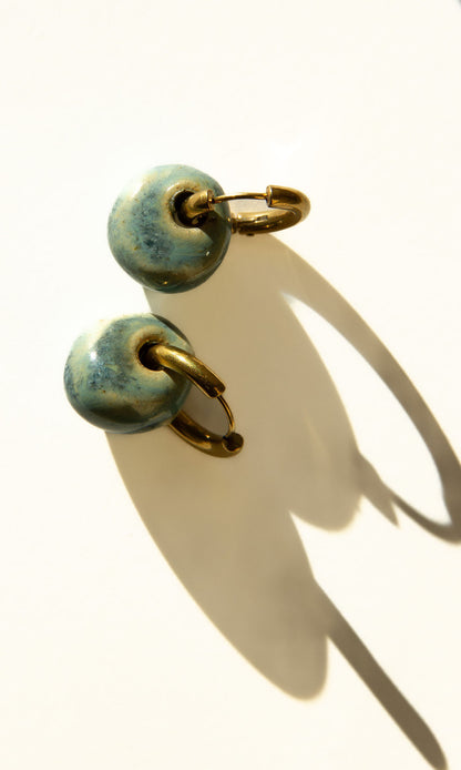 Gomes handmade ceramic earrings in Sparkling Blue — rounded circular form, bold yet discreet, made in Lisbon Portugal by Jadeo Studio, silver and gold hoop