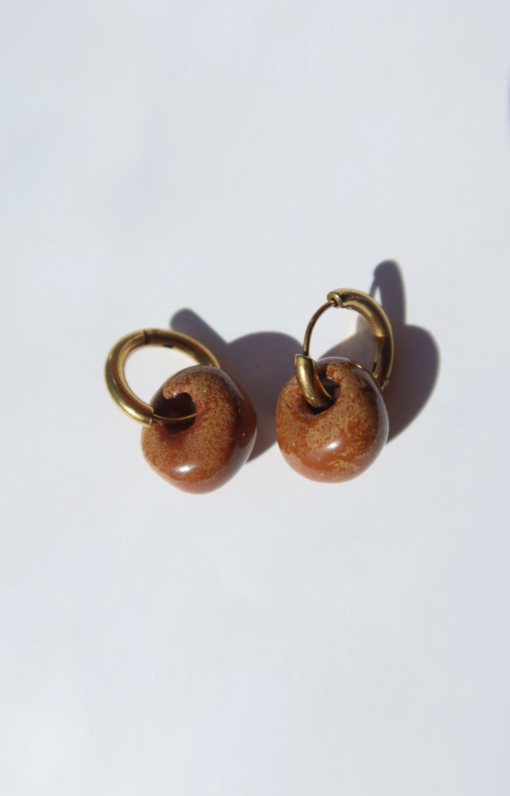 Gomes handmade ceramic earrings in Sparkling Brown — rounded circular form, bold yet discreet, made in Lisbon Portugal by Jadeo Studio