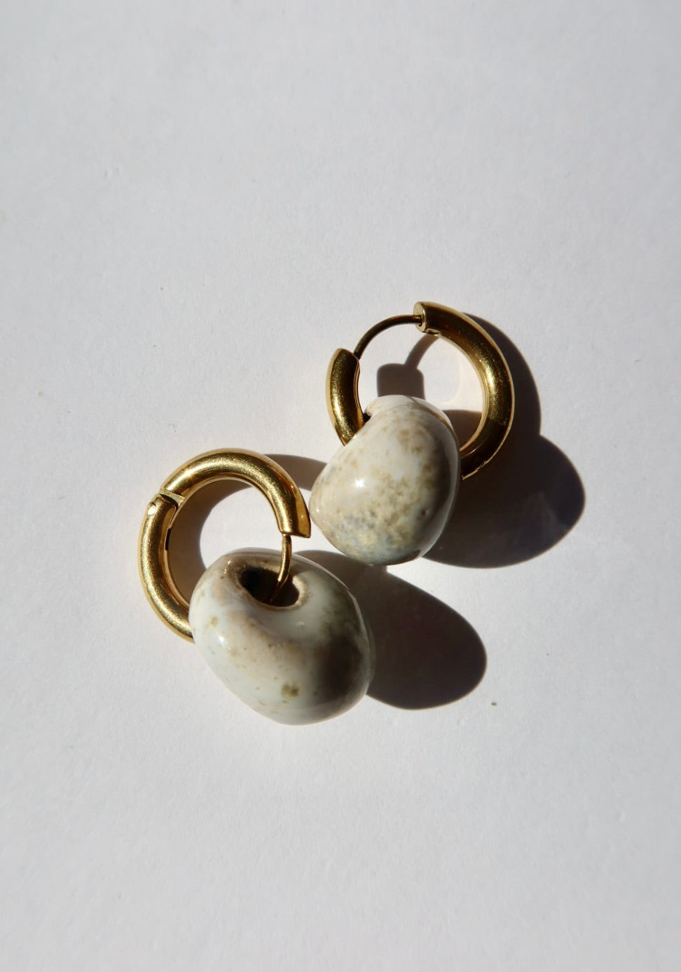 Gomes handmade ceramic earrings in Sparkling White — rounded circular form, bold yet discreet, made in Lisbon Portugal by Jadeo Studio