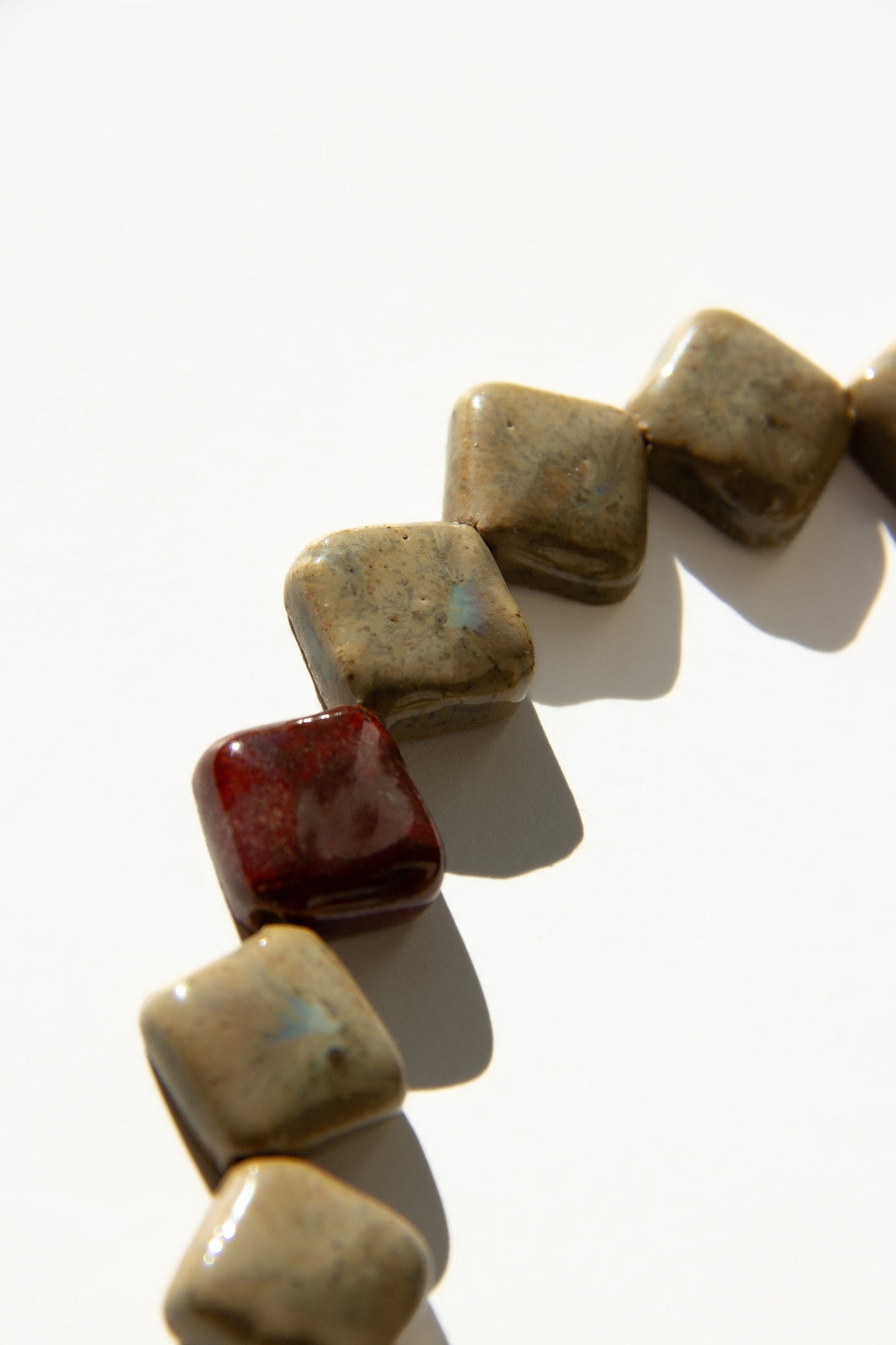 Monti handmade ceramic choker necklace in Beige and Burgundy — sculptural beads inspired by Roman architecture, made in Lisbon Portugal by Jadeo Studio, Lisbon lifestyle