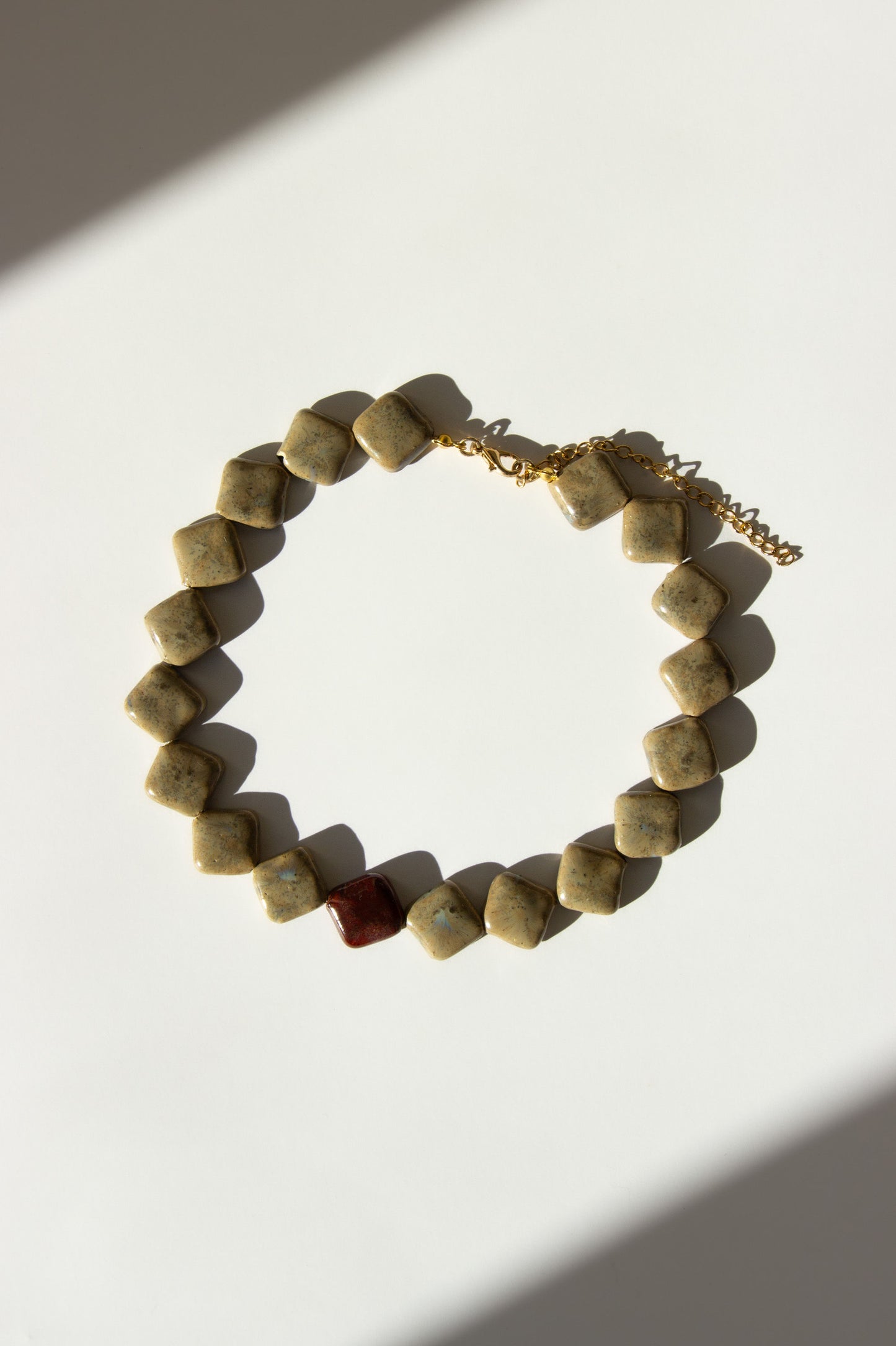 Monti handmade ceramic choker necklace in Beige and Burgundy — sculptural beads inspired by Roman architecture, made in Lisbon Portugal by Jadeo Studio