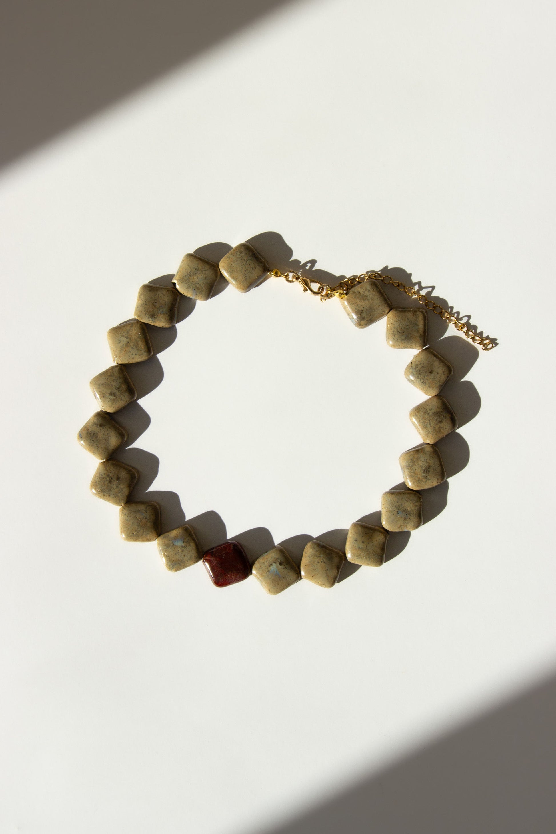Monti handmade ceramic choker necklace in Beige and Burgundy — sculptural beads inspired by Roman architecture, made in Lisbon Portugal by Jadeo Studio