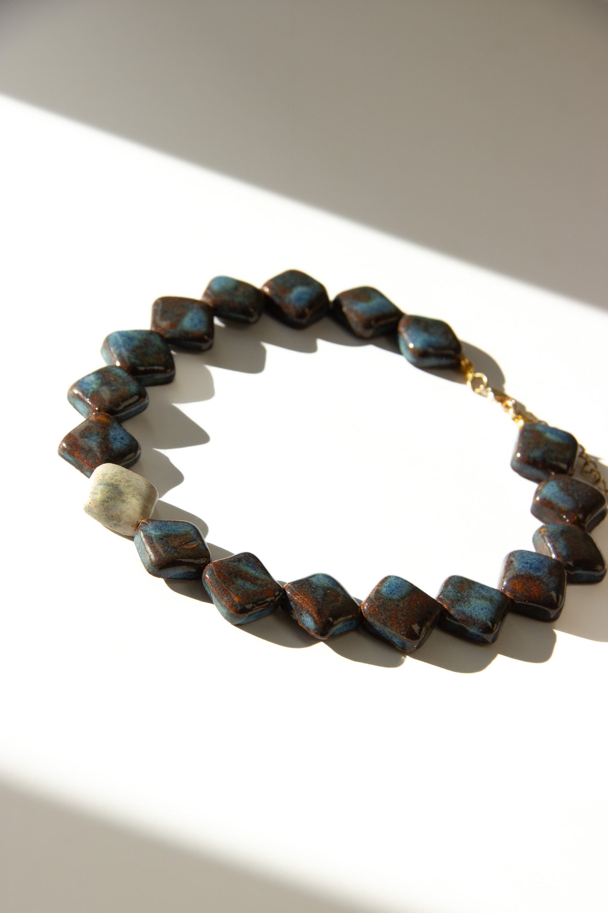 Monti handmade ceramic choker necklace in Blue Jeans and White — sculptural beads inspired by Roman architecture, made in Lisbon Portugal by Jadeo Studio