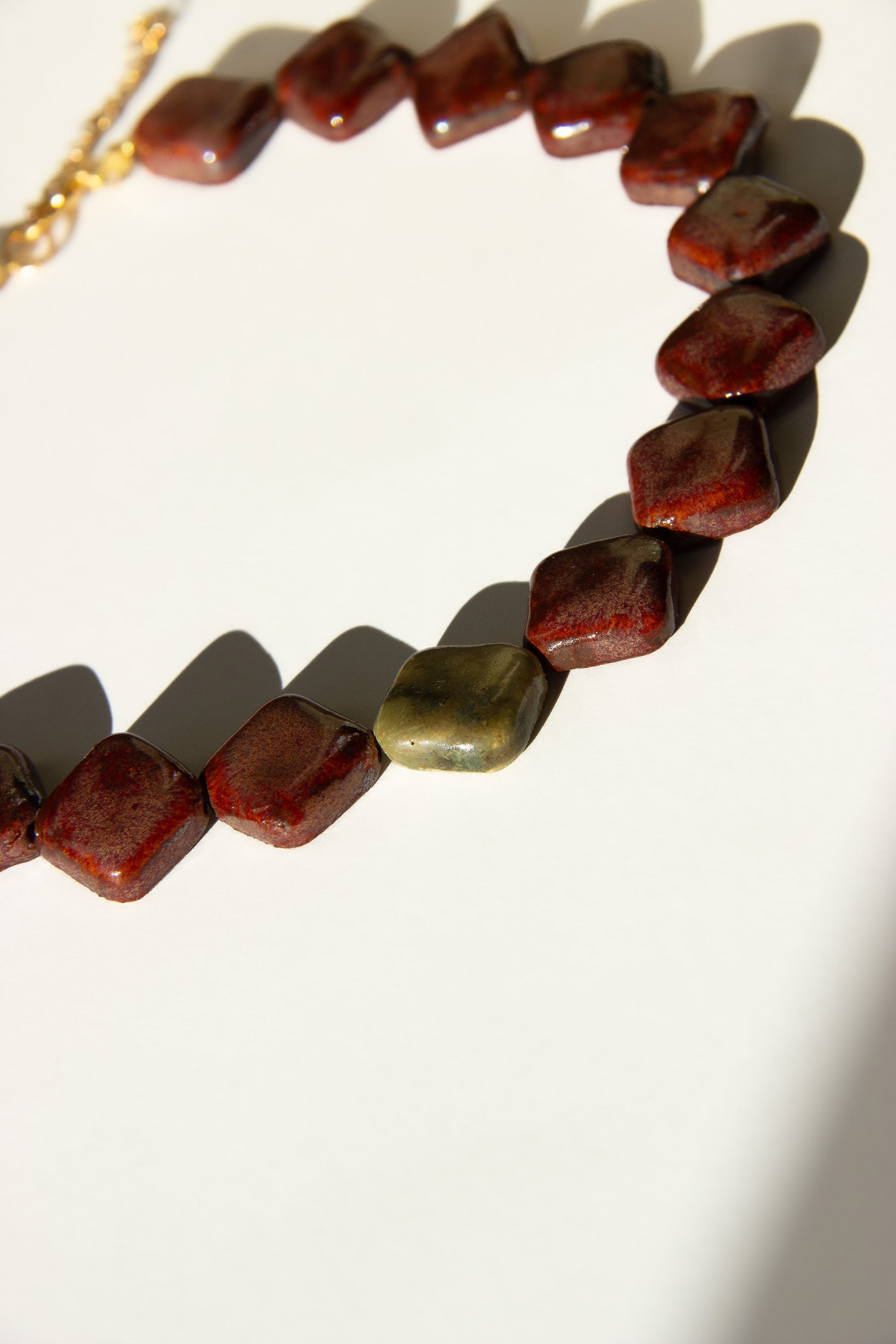 Monti handmade ceramic choker necklace in Burgundy and Light Green — sculptural beads inspired by Roman architecture, made in Lisbon Portugal by Jadeo Studio, Lisbon lifestyle