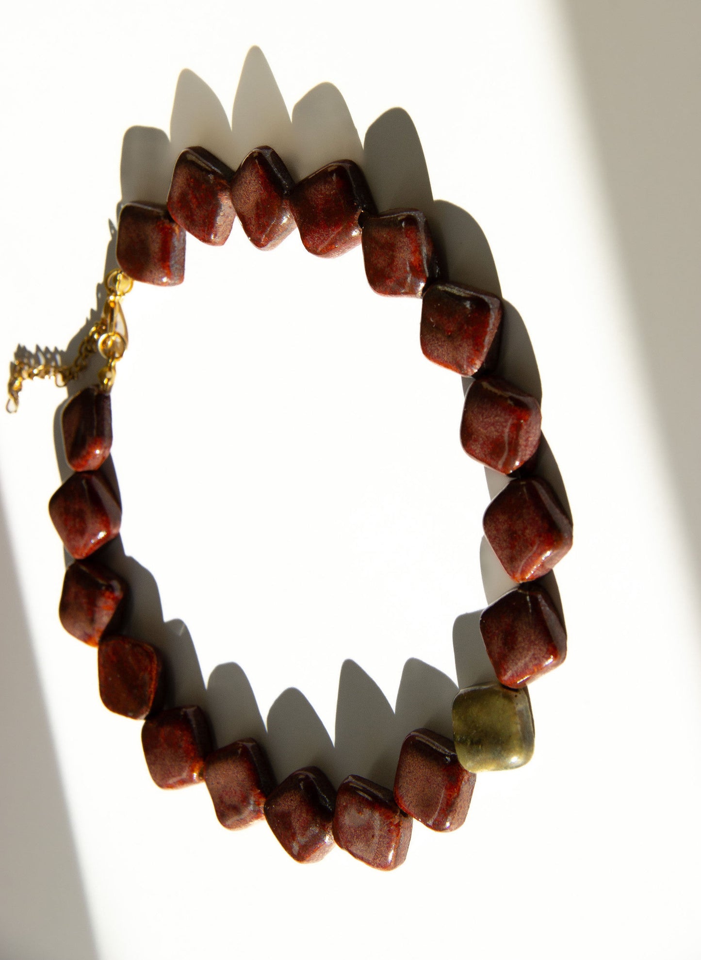 Monti handmade ceramic choker necklace in Burgundy and Light Green — sculptural beads inspired by Roman architecture, statement jewelry made in Lisbon Portugal by Jadeo Studio