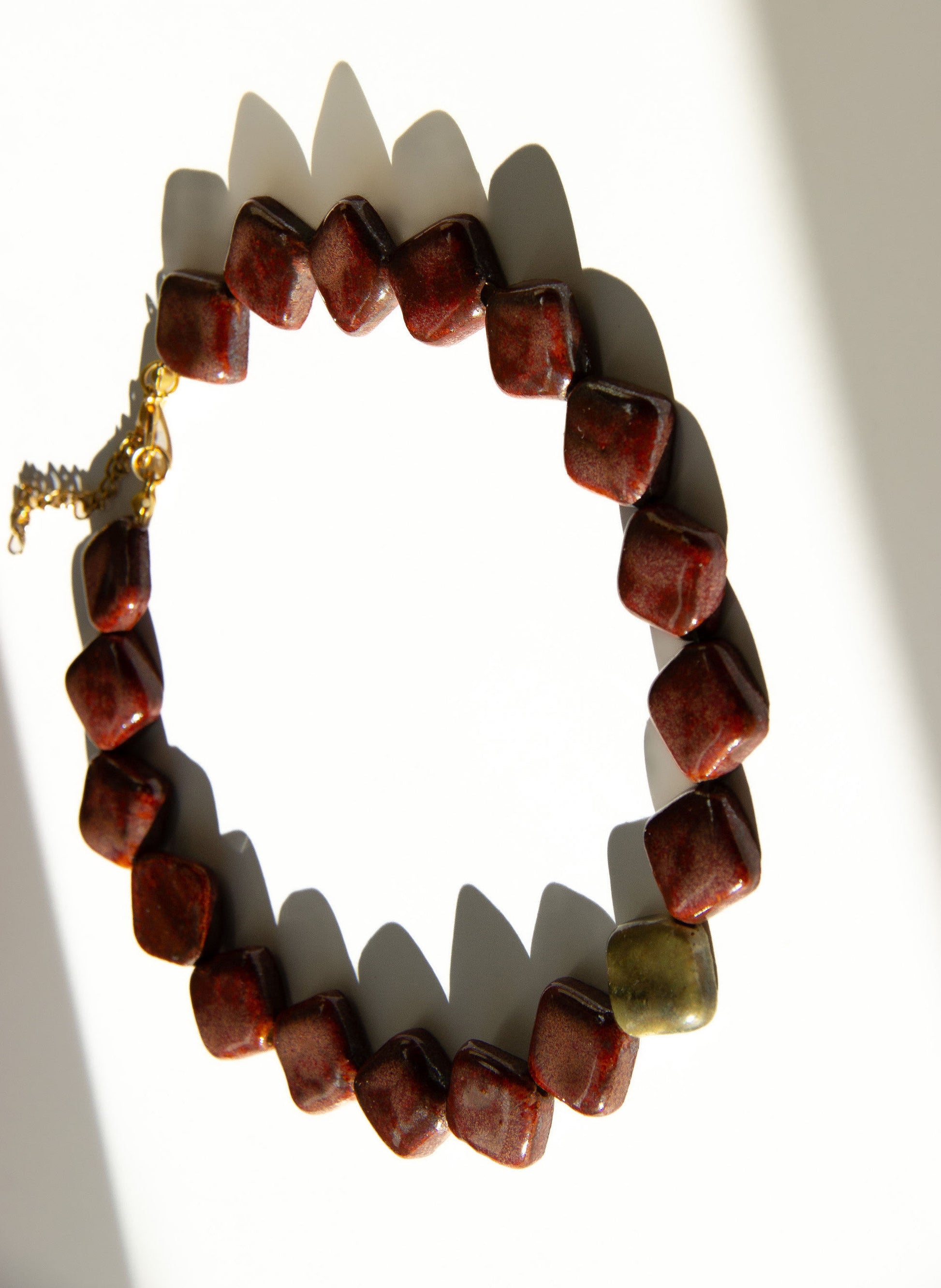 Monti handmade ceramic choker necklace in Burgundy and Light Green — sculptural beads inspired by Roman architecture, statement jewelry made in Lisbon Portugal by Jadeo Studio
