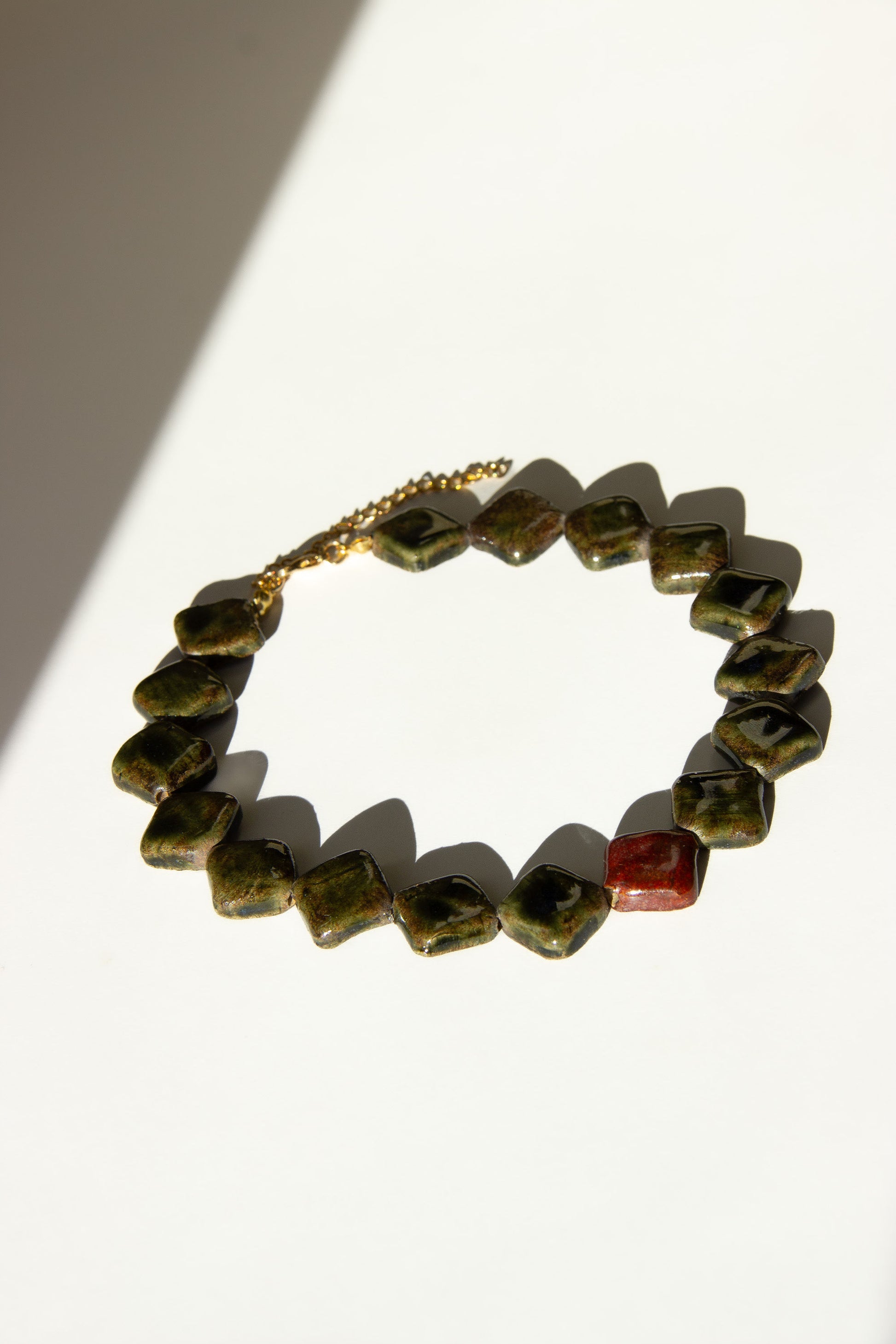 Monti handmade ceramic choker necklace in Dark Green and Burgundy — sculptural beads inspired by Roman architecture, made in Lisbon Portugal by Jadeo Studio, unique jewelry