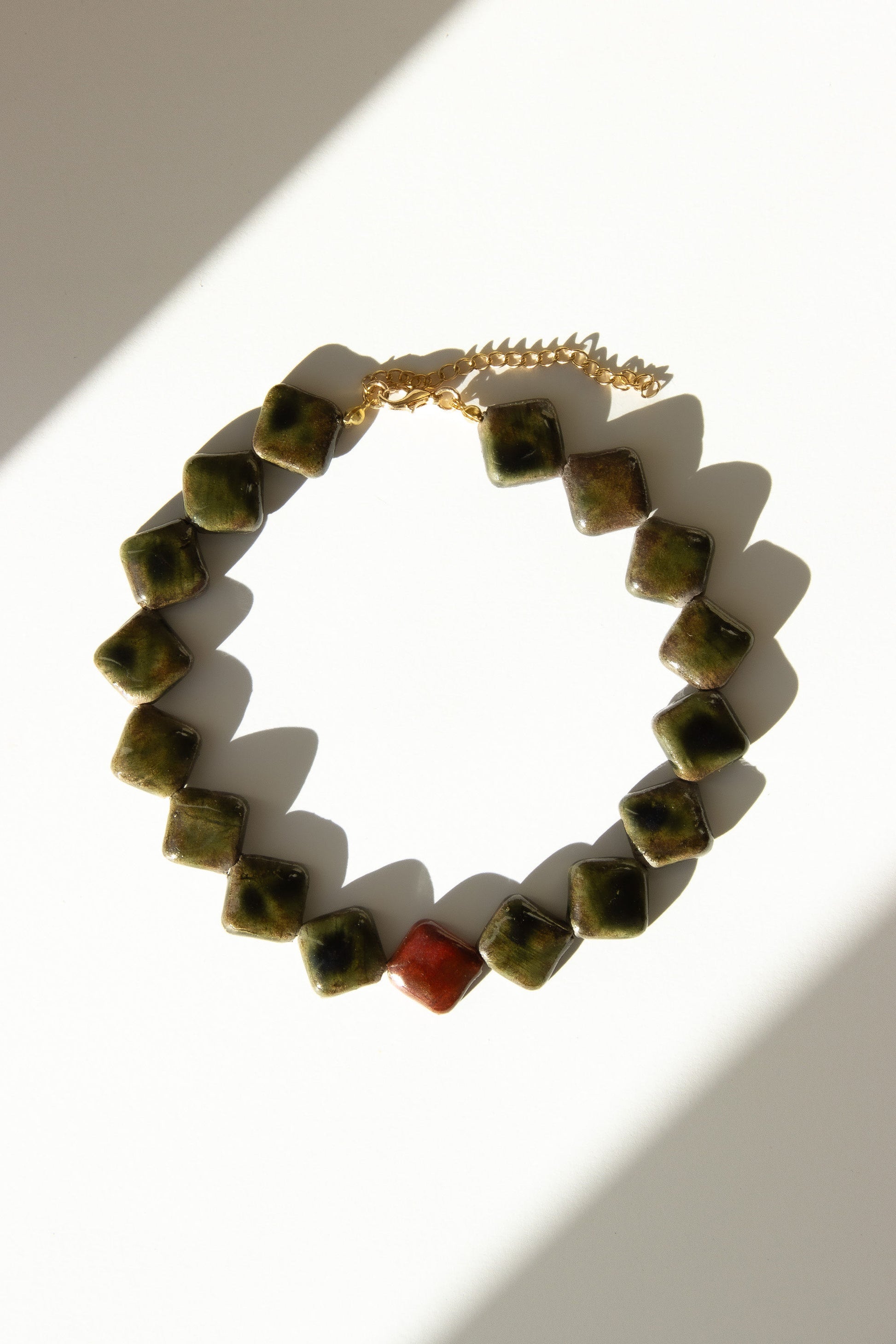 Monti handmade ceramic choker necklace in Dark Green and Burgundy — sculptural beads inspired by Roman architecture, made in Lisbon Portugal by Jadeo Studio