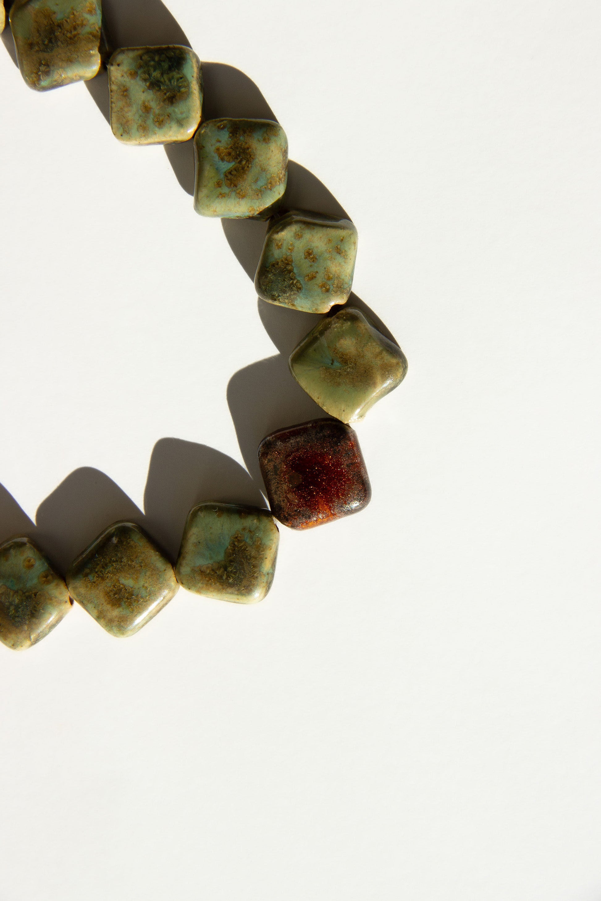 Monti handmade ceramic choker necklace in Light Green and Bark, glossy glaze — sculptural beads inspired by Roman architecture, made in Lisbon Portugal by Jadeo Studio