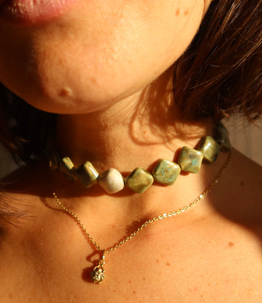 Monti handmade ceramic choker necklace in Light Green and Sparkling White worn on soft skin with sunlight— sculptural beads inspired by Roman architecture, made in Lisbon Portugal by Jadeo Studio