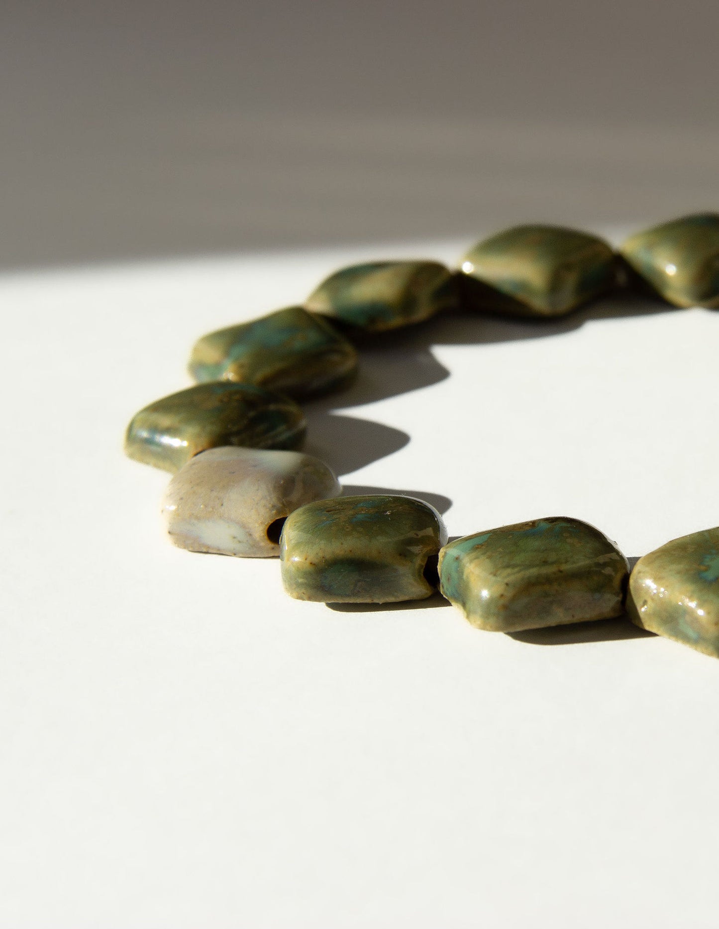 Monti handmade ceramic choker necklace in Light Green and Sparkling White, flat beads — sculptural beads inspired by Roman architecture, made in Lisbon Portugal by Jadeo Studio