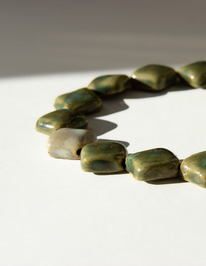 Monti handmade ceramic choker necklace in Light Green and Sparkling White, flat beads — sculptural beads inspired by Roman architecture, made in Lisbon Portugal by Jadeo Studio