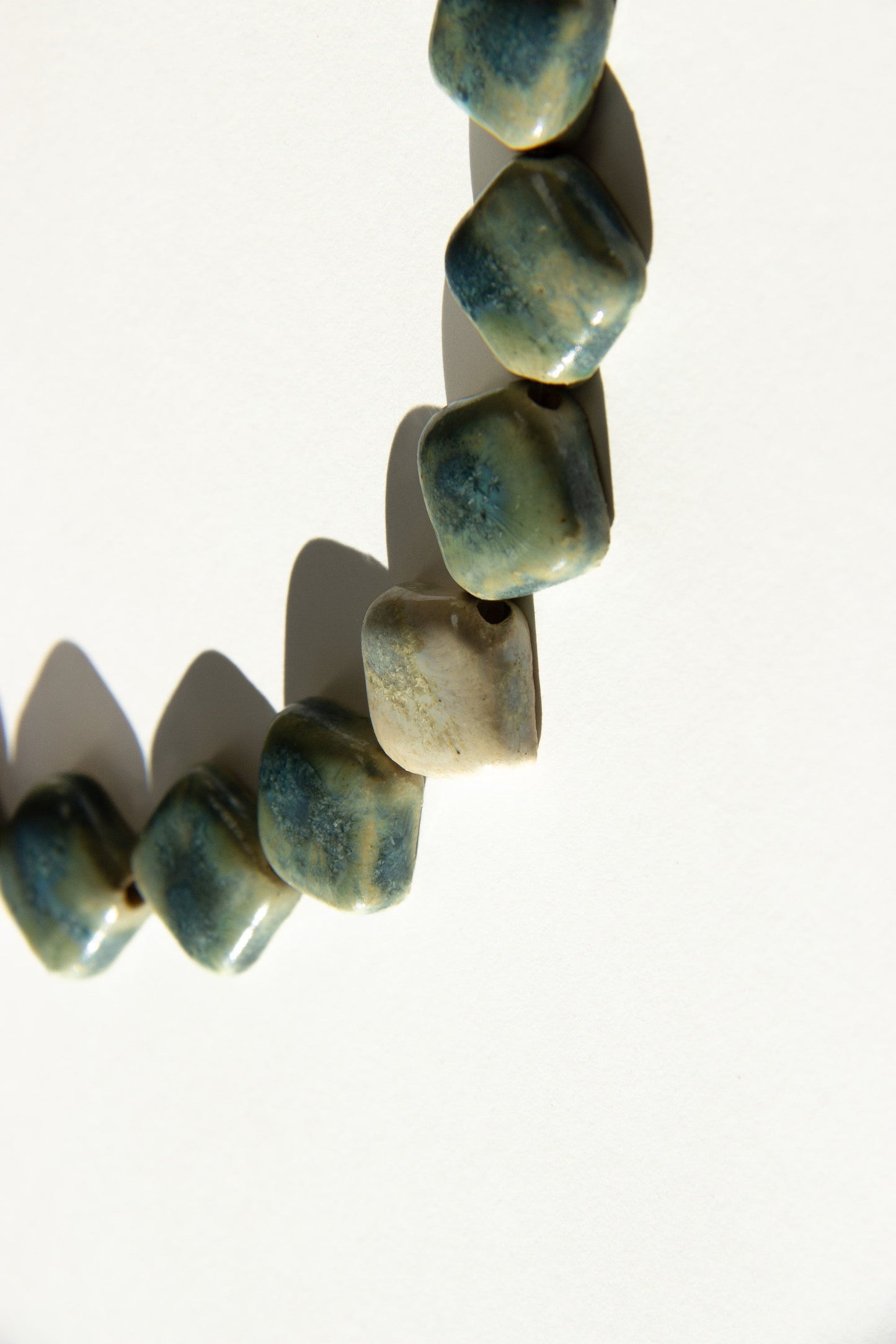 Monti handmade ceramic choker necklace in Sparkling Blue and White, glossy glaze— sculptural beads inspired by Roman architecture, made in Lisbon Portugal by Jadeo Studio