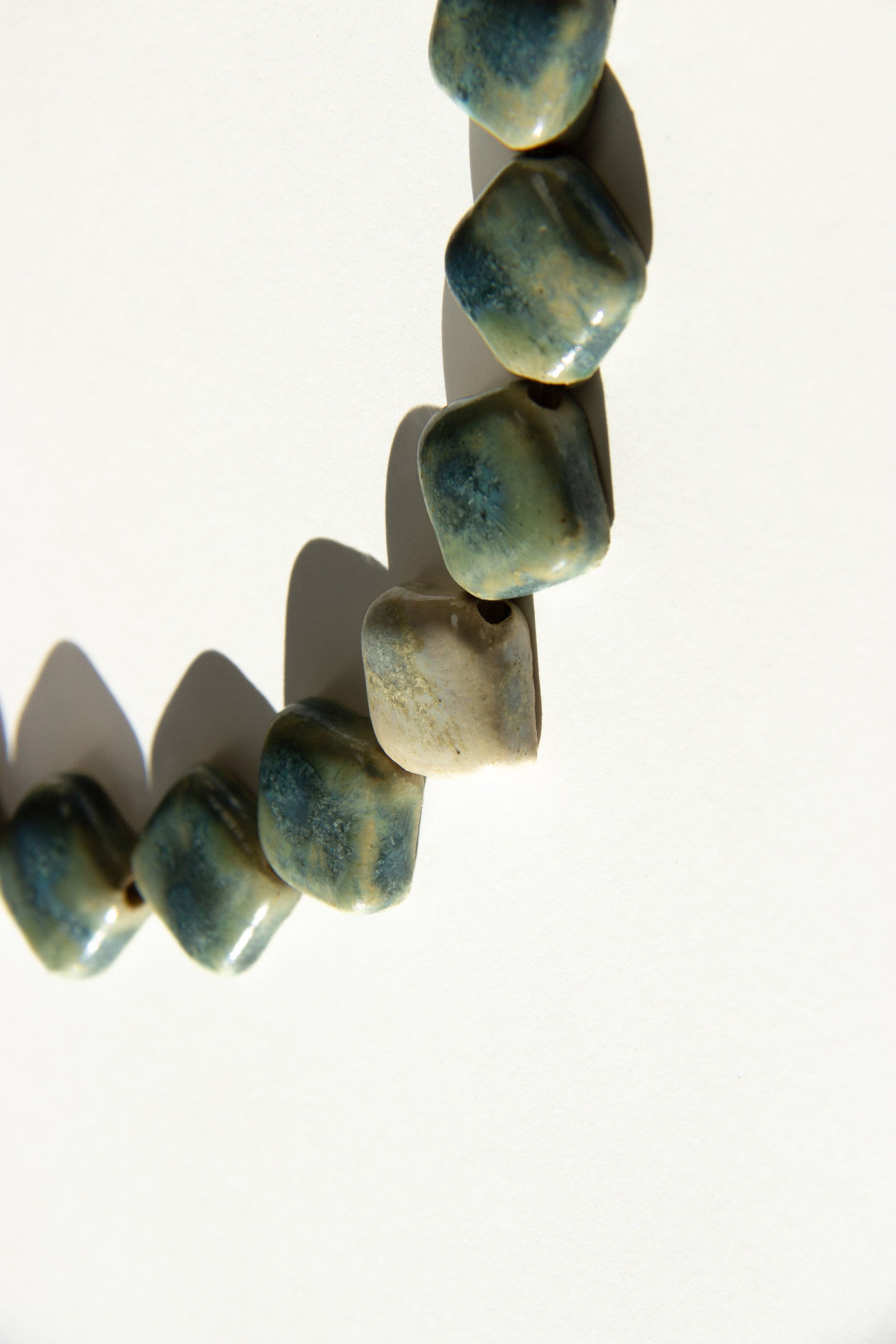 Monti handmade ceramic choker necklace in Sparkling Blue and White, glossy glaze— sculptural beads inspired by Roman architecture, made in Lisbon Portugal by Jadeo Studio