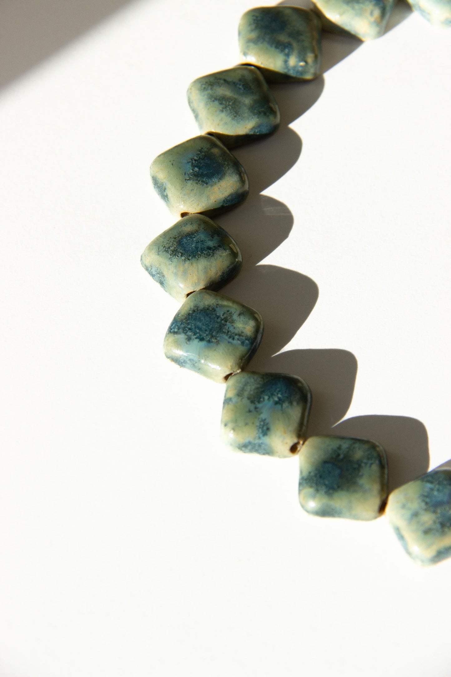 Monti handmade ceramic choker necklace in Sparkling Blue and White — sculptural beads inspired by Roman architecture, statement jewelry made in Lisbon Portugal by Jadeo Studio