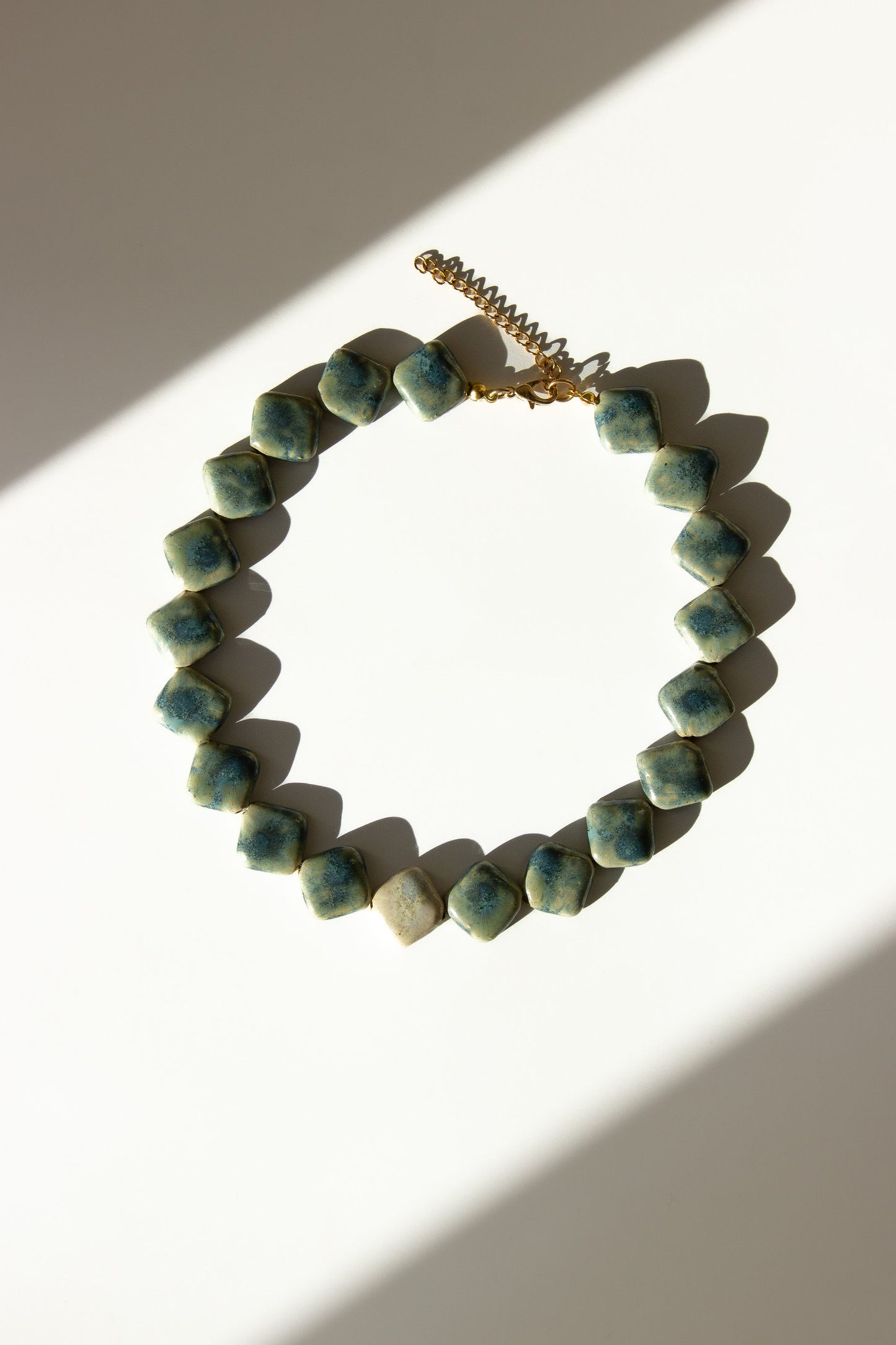 Monti handmade ceramic choker necklace in Sparkling Blue and White — sculptural beads inspired by Roman architecture, made in Lisbon Portugal by Jadeo Studio