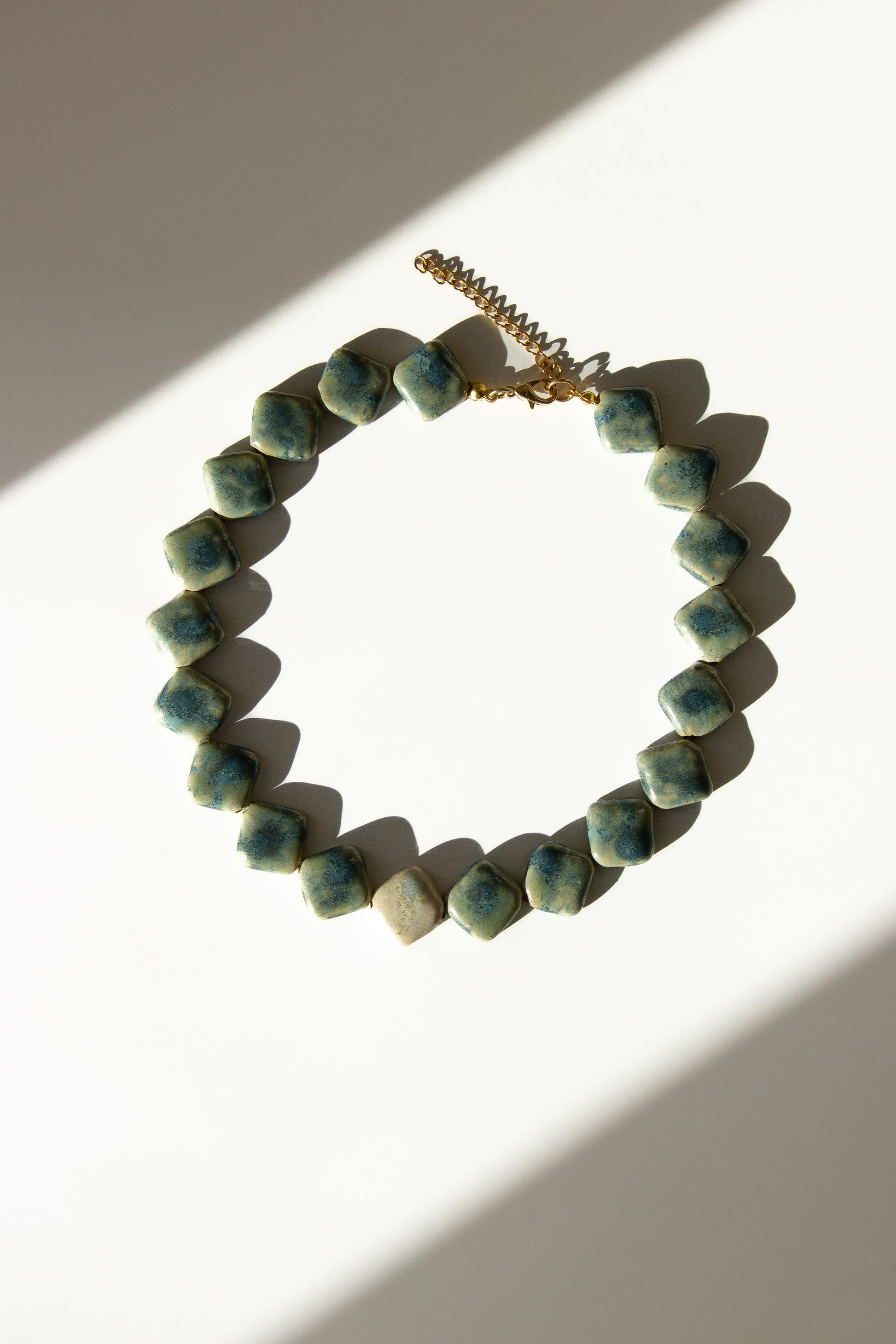 Monti handmade ceramic choker necklace in Sparkling Blue and White — sculptural beads inspired by Roman architecture, made in Lisbon Portugal by Jadeo Studio